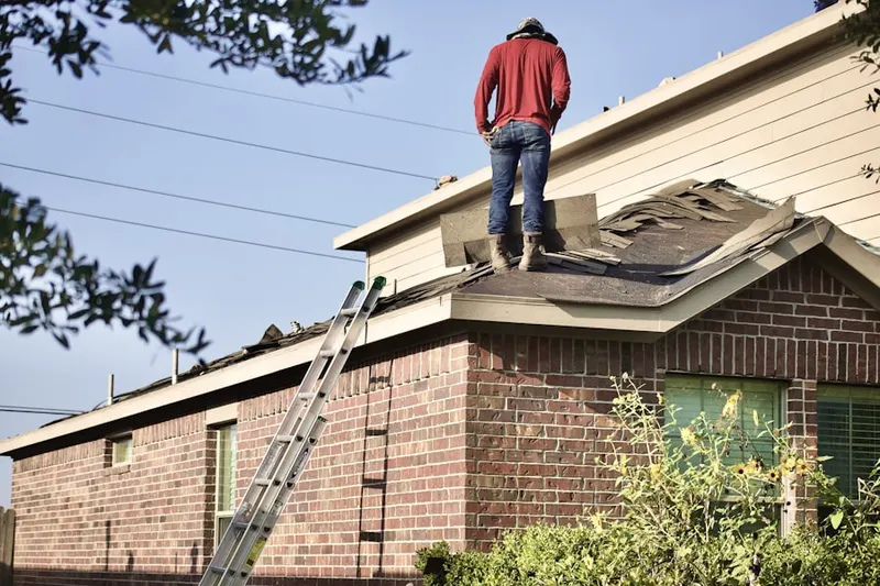 Professional roofer working on a residential roof in East Midvale
